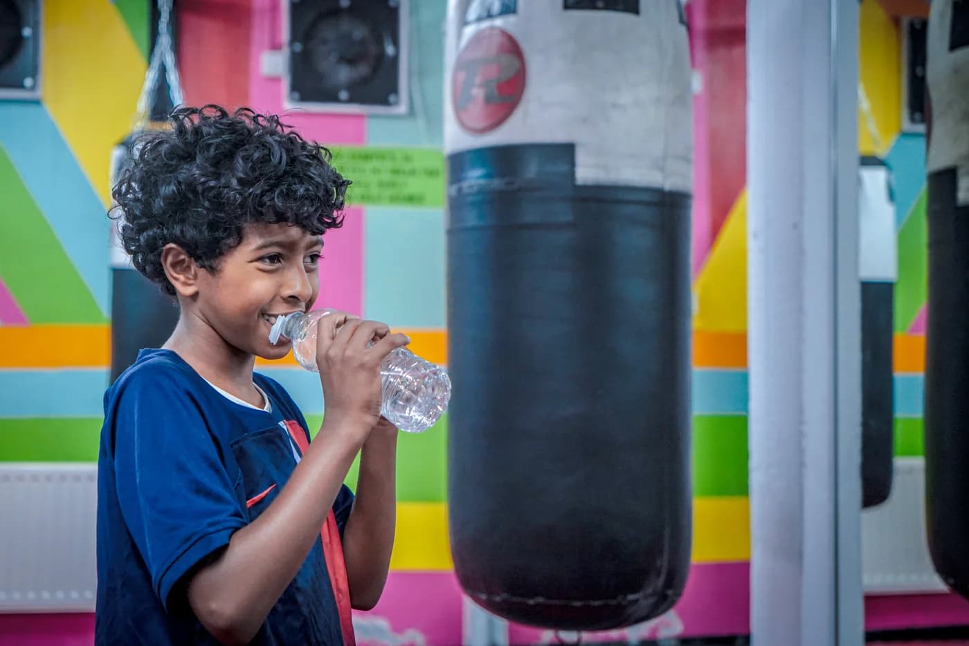 A young participant smiling during a break at the martial arts session