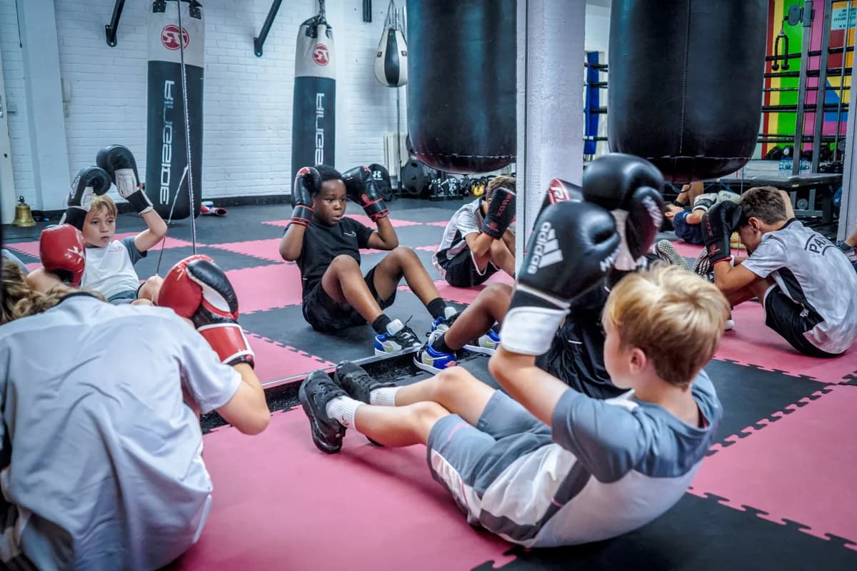 Young participants training together on the mats
