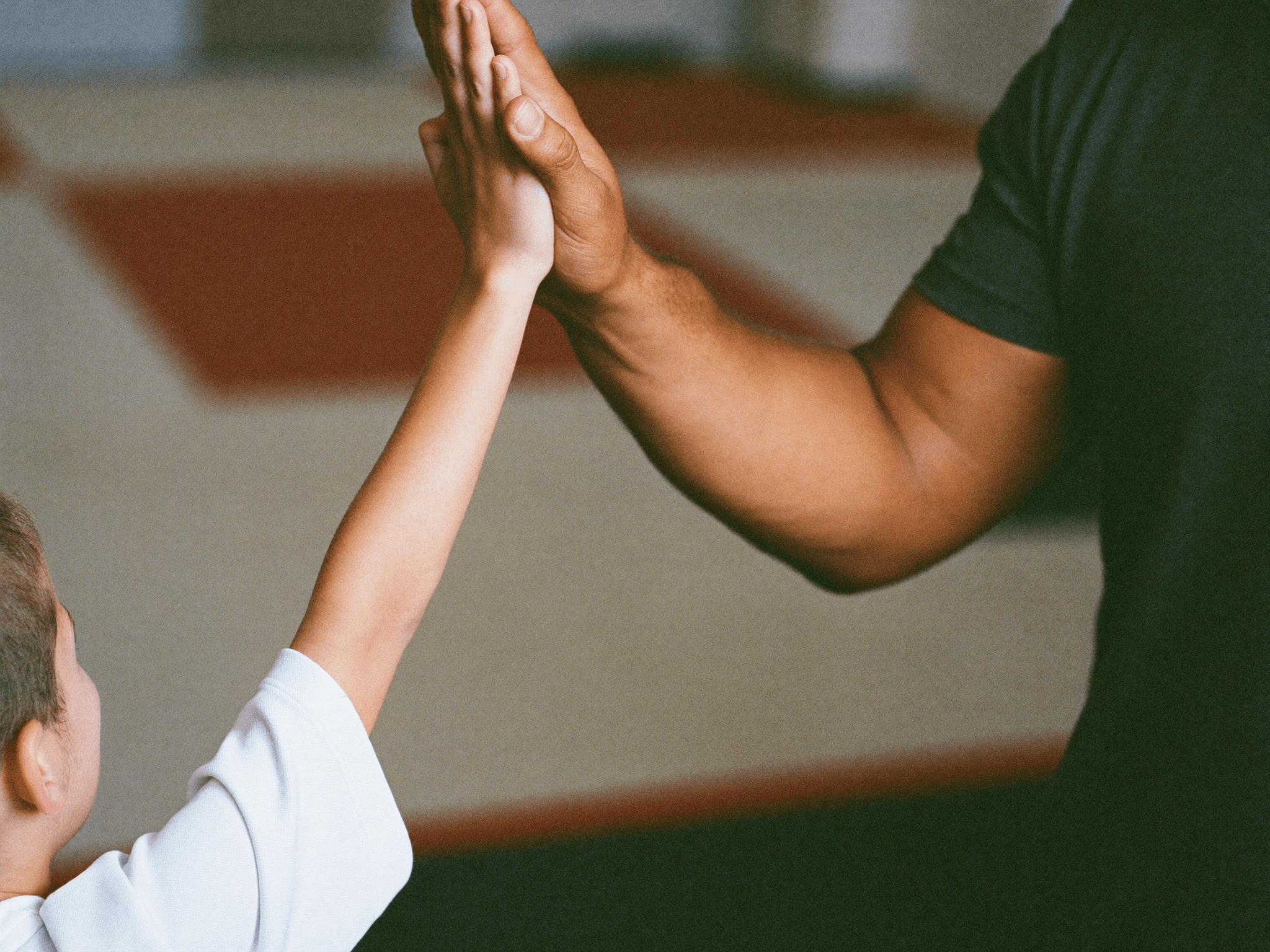 Kids learning martial arts in a supportive gym environment